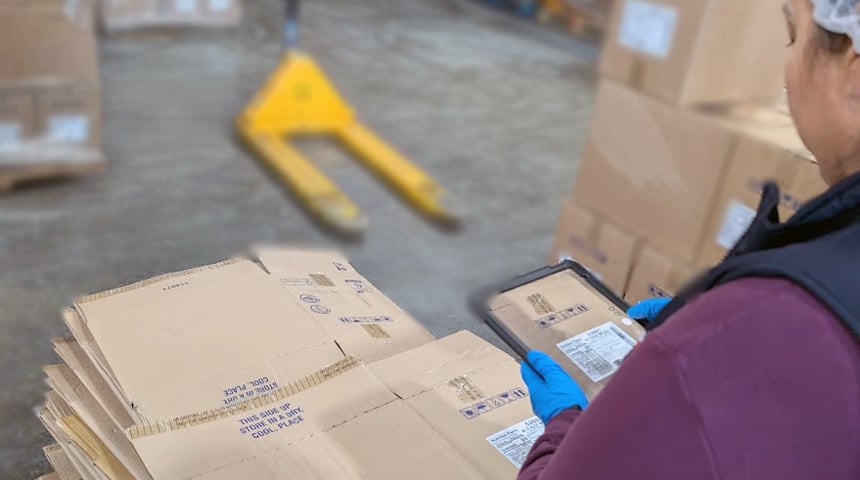 Quality control inspector documenting hourly inspection results at contract packaging facility