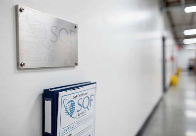 SQF Level 2 certification documentation at a contract packaging facility