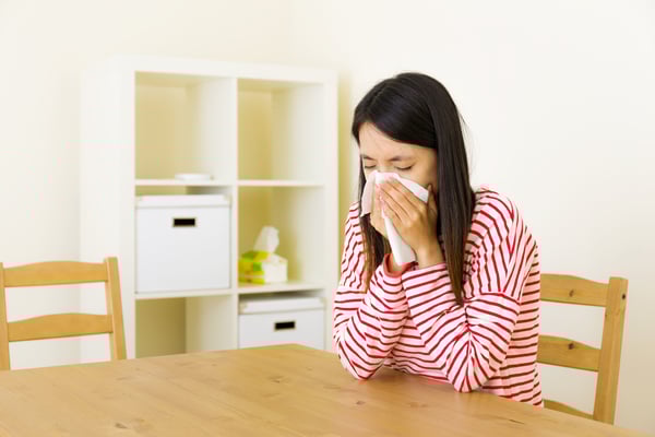 Asian woman sneezing