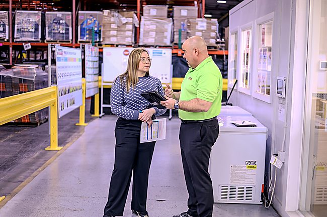 Cross-trained packaging team members reconfiguring a modular production line for a club store multipack format changeover
