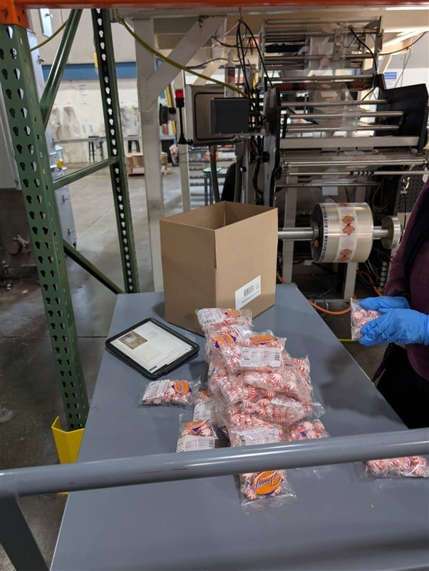 Quality inspection of confectionery variety pack or allergen control process with staff reviewing product segregation protocols