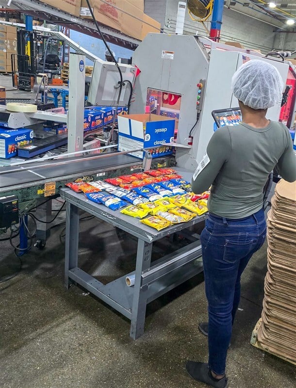 Quality inspector with tablet conducting inspection at production line